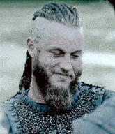 a man with a beard and braids is smiling