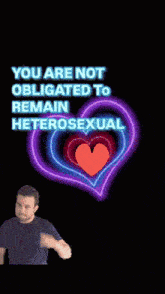 a man is standing in front of a neon heart that says you are not obligated to remain heterosexual