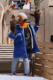 a stuffed animal wearing a blue coat and a black shirt that says ' i love you ' on it