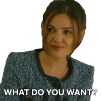 a woman in a blue jacket with the words what do you want below her
