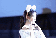 a woman wearing a headband with white bunny ears