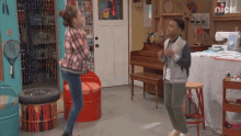 a boy and a girl are dancing in a room with the nick logo on the bottom