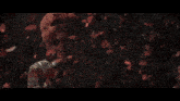 a woman with red hair is surrounded by petals falling from the sky