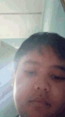 a close up of a child 's face with a blue background