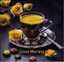 a cup of coffee on a saucer with yellow roses and chocolates and the words good morning written on the bottom