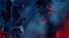 a cartoon dragon with a purple head and green eyes is standing in a dark room .