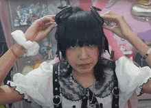 a person wearing a headband with horns and a necklace that says ' i love you ' on it