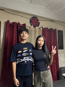 a boy and a girl are posing for a picture in front of a clock that shows the time as 7:23