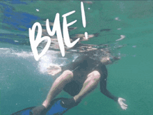 a man is swimming in the ocean with the word bye written in the water