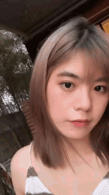 a close up of a girl 's face with a striped top on