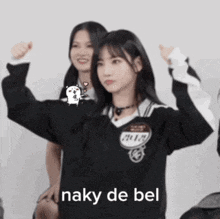 a girl in a black sweater has the word naky de bel on her shirt