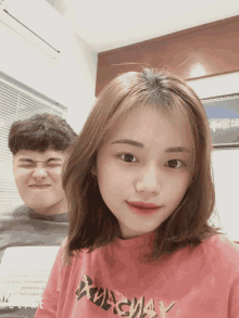 a girl wearing a pink shirt that says xmasway looks at the camera