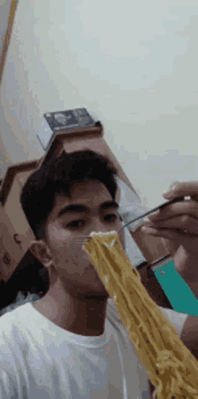a man is eating spaghetti with a fork in his mouth