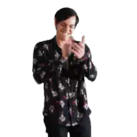 a man wearing a floral shirt is smiling and giving a thumbs up