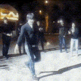 a blurry picture of a group of people dancing in front of a sign that says ' la '