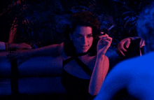 a woman in a black dress smoking a cigarette