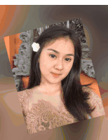 a woman with a flower in her hair is looking at the camera