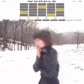 a woman standing in a snowy field next to a wordle display