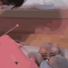 a person is laying on a bed with chinese writing on the bottom of the image .