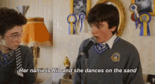 a boy singing into a microphone with the words her name is rio and she dances on the sand above him
