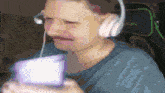a man wearing headphones is holding a box