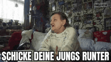 an elderly woman is sitting on a couch in a living room and talking to someone .