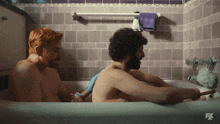 two men in a bathtub with the fx logo on the bottom right