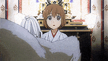 a boy and a girl are standing next to each other in a room with a statue in the background .