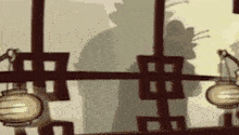 a shadow of a man standing in front of a window with lanterns hanging from the ceiling .