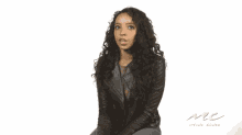 a woman in a leather jacket is holding a sign that says i never