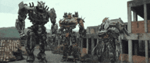 three robots are standing in front of a building