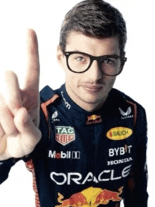 a man wearing glasses is wearing a racing suit with oracle written on it