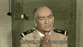 a man in a military uniform prays with the words " suivez mon exemple " written below him