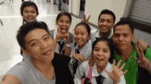 a group of young people are posing for a picture and one of them is wearing a green shirt