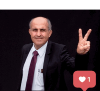 a man in a suit and tie giving a peace sign next to a like button