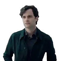 a man wearing a black jacket and a grey shirt looks serious