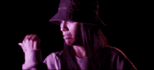 a woman wearing a purple hat and a purple sweater