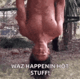 a shirtless man is hanging upside down on a rope .