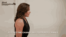 a woman standing in front of a door that says i 'll get the chanel all over body spray