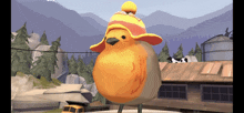 a bird wearing a red and yellow hat stands in front of a building