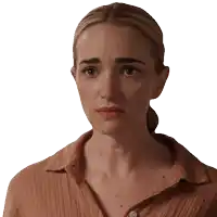 a close up of a woman 's face with a serious look on her face