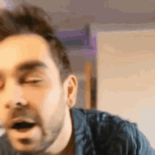a close up of a man 's face with his eyes closed .