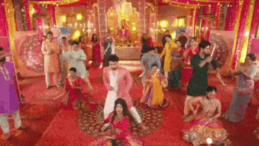 a group of people are dancing together in a room .