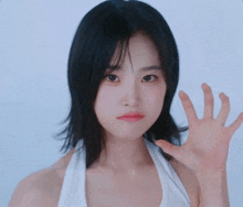 a woman with her eyes closed is making a face with her hands