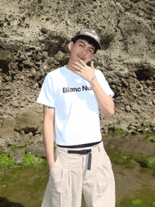 a man wearing a white t-shirt that says blanc nu on it