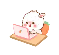 a cartoon rabbit is sitting at a table using a laptop