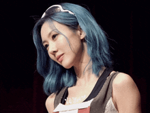 a woman with blue hair is wearing sunglasses and a shirt that says peace on it