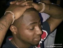 a man with his hands on his head has a tiktok comment on the bottom right