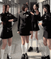 a group of girls are standing in a hallway and one of them has a name tag that says ' a ' on it