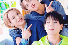a group of young men are posing for a picture and one of them is pointing at the camera